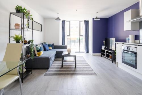 a living room with a couch and a table at Hemel Apartments - Lilac Luxe in Hemel Hempstead