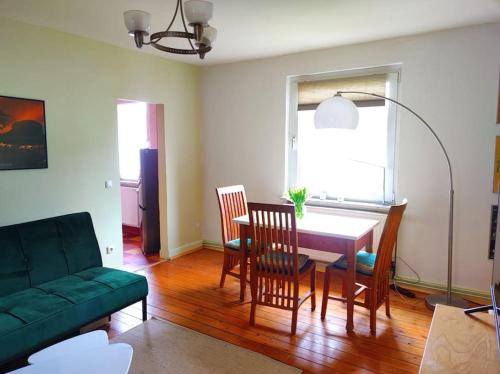 un salon avec une table, des chaises et un canapé dans l'établissement Ruhrpott-Paradies, à Duisbourg