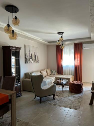 a living room with a couch and a table at Lux Apartman Jovana in Žabljak