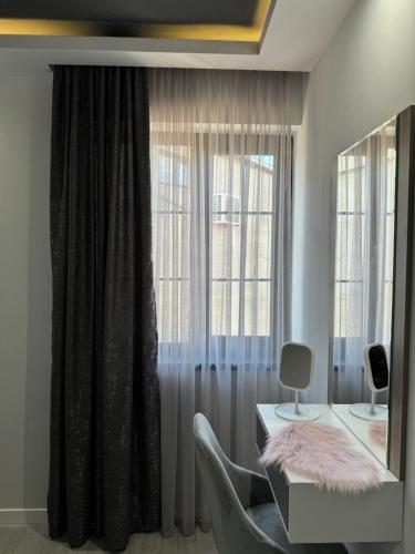 a living room with a table and a window at Mon Invite Hotel in Yerevan