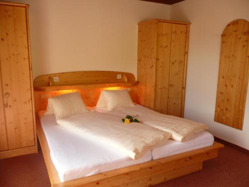 a bedroom with a white bed with flowers on it at Apart Renate in Galtür