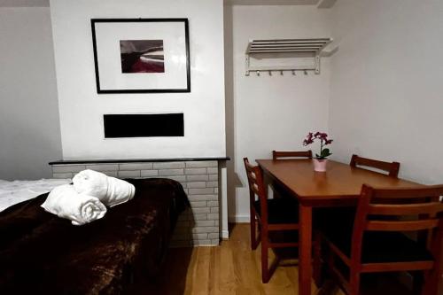 a living room with a table and a table and a dining room at Gatesden Guest House in London