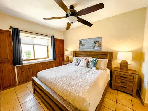 une chambre avec un lit et un ventilateur de plafond dans l'établissement Princesa de Penasco Condo C101 Sandy Beach Puerto Penasco, à Puerto Peñasco