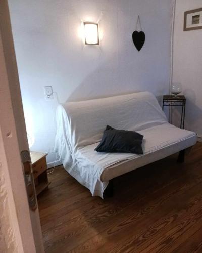 a bed with a pillow on it in a room at Appartement LE COURS in Barbentane