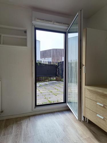 an empty room with a sliding glass door at Studio avec grande terrasse gare Sud in Nantes