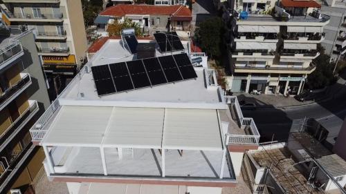 an overhead view of a building with solar panels on the roof at Euphoria luxury penthouse in Kavala
