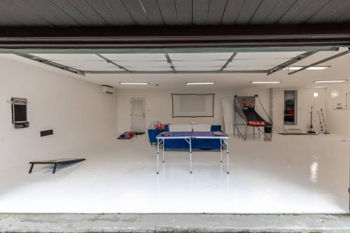 a garage with a ping pong table in it at Luxury-Cabin Mount View *Gym*Game Room *Fire Place in Lehighton