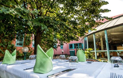 a table with green napkins on top of it at Holiday Inn Budapest-Budaörs by IHG in Budaörs