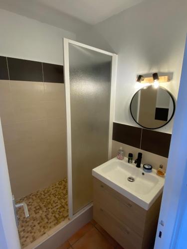 a bathroom with a sink and a mirror at Appt T3 front de mer belle vue in Narbonne