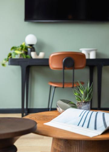a table with a plant sitting on top of it at Albi Florentin - Traveler's Choice 2025 in Tel Aviv