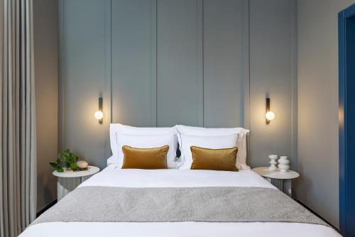 a bedroom with a large white bed with two side tables at Albi Florentin - Traveler's Choice 2025 in Tel Aviv