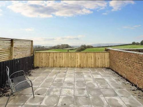 a chair sitting on a patio with a fence at Sea View Retreat in Lingdale