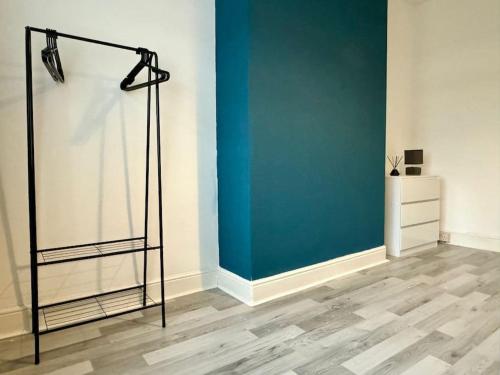 a room with a blue wall and a floor at Sea View Retreat in Lingdale