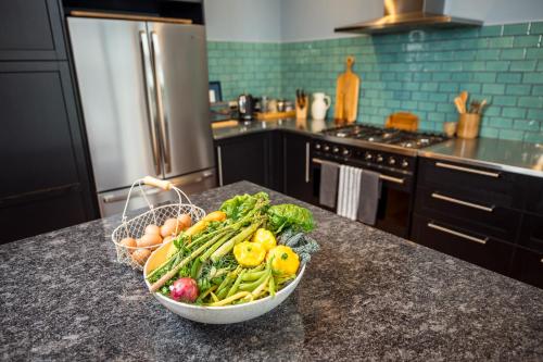 a bowl of vegetables on a counter in a kitchen at The Overflow Blue Mountains in Kanimbla