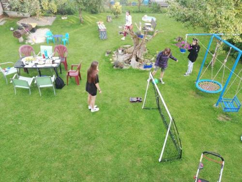 a group of people playing a game in a yard at Apartmány MK u MODRÉ KOČKY in Nové Hrady