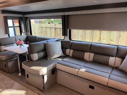 a living room with a couch and a table at Free BBQ in RV With Private entrance in Homestead