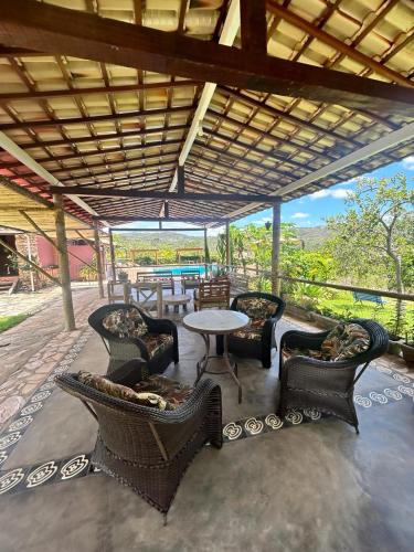 a patio with chairs and a table and a table and chairs at Pousada Serra Morena in Serra do Cipo