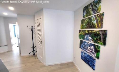 a room with three paintings on the wall at Castelo do Mar, Madeira in Tábua
