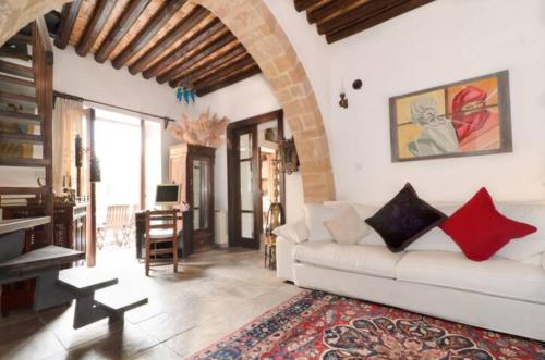 a living room with a white couch and a table at Historical House in the Old City of Nicosia in Nicosia