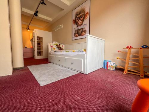 a childs room with a white crib in a room at Seehotel Riviera at Lake Lucerne in Gersau