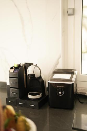 a kitchen with a toaster and a printer on a counter at Mazzarò Luxury Apartment Taormina in Taormina