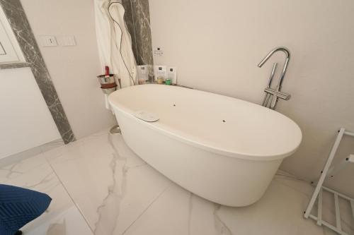 a white toilet in a white bathroom with a sink at Mazzarò Luxury Apartment Taormina in Taormina