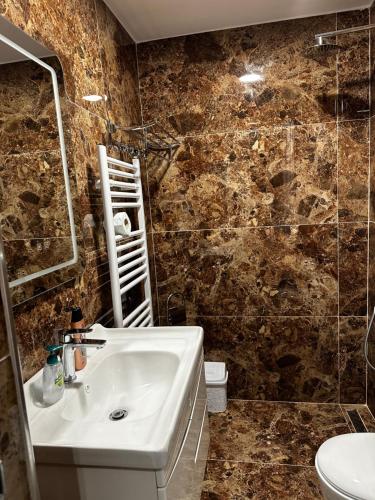 a bathroom with a sink and a toilet at 4 Stinët in Valbonë