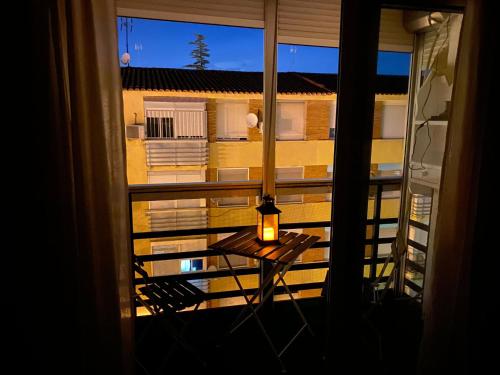 a view of a balcony with a candle on a table at Espacioso Apartamento Familiar con terraza en Aranjuez - Confort, Tranquilidad y Netflix Incluido in Aranjuez