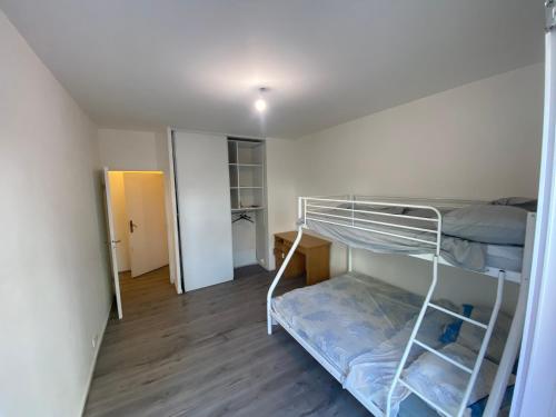 a room with two bunk beds and a hallway at appartement proche de paris in Saint-Denis