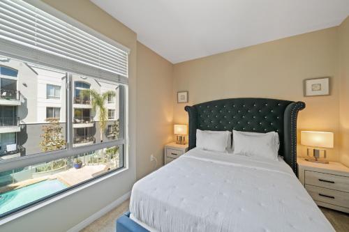 a bedroom with a bed and a large window at Venice Marina Pool and Spa Luxury Condo in Los Angeles