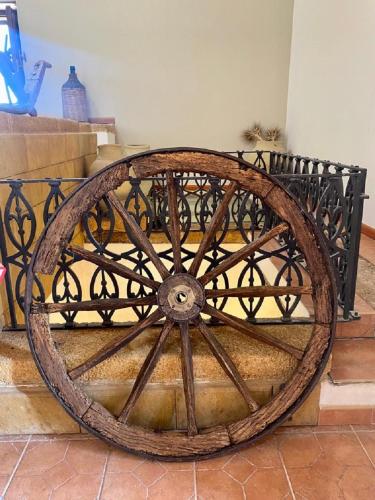 a wooden wagon wheel sitting next to a bench at B&B Le Balate in Augusta