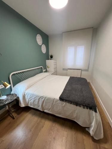 a bedroom with a large bed and a window at Casa Las Pozas in Olite