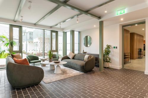 an office lobby with couches and chairs and a table at The Lookout in Dublin