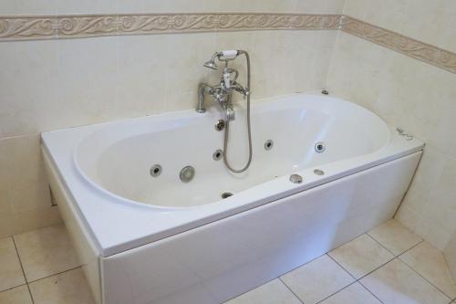 a white bath tub in a bathroom at Deluxe Dwelling - 15 mins from Cork City/Airport in Cork