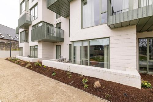 a white building with windows and plants in a yard at The Lookout in Dublin