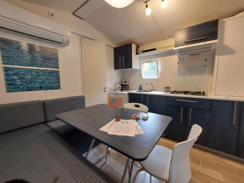 a kitchen with a table and chairs in a room at Villaggio Turistico Il Lago Dorato in Carlazzo