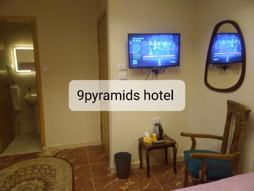 a hotel room with a tv on the wall at 9pyramids hotel in Cairo