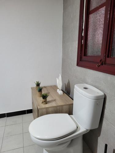 a white toilet in a bathroom with a window at El patio de Iria in Porto Cristo