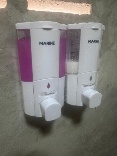two back end of a white and purple appliance at NADOHN-Homestay in Ban Nam Lai Ta Tum
