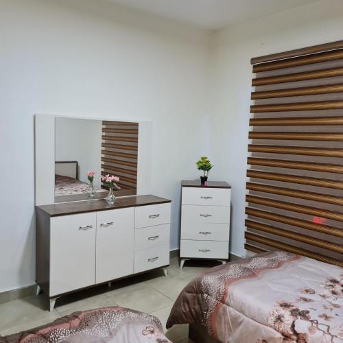 a bedroom with a mirror and a bed and a dresser at 2 bedrooms apartment no 18 in Amman