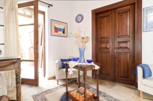 a living room with a table and a vase of flowers at Studio in the Old City of Nicosia in Nicosia