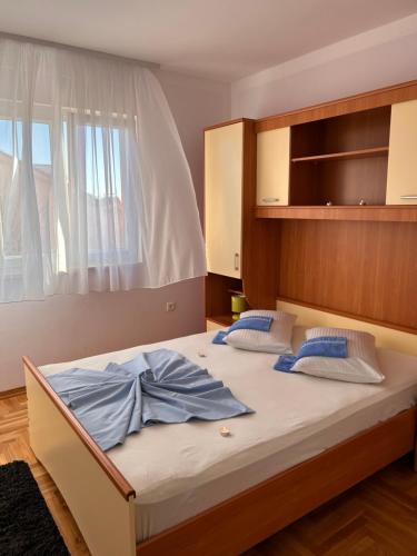 a bed with two pillows on it in a bedroom at Apartment Agata in Trogir