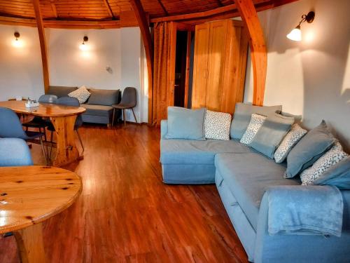 a living room with a blue couch and a table at KupolaVilla-Apartment-Event house by the Danube river-Buda in Budapest