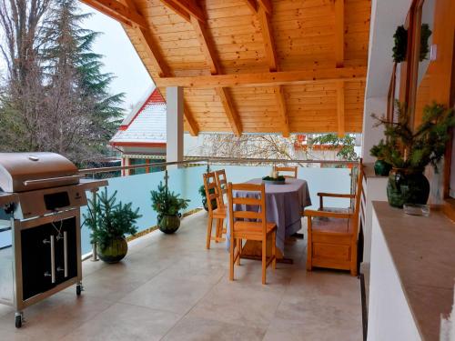 a patio with a table and chairs and a grill at KupolaVilla-Apartment-Event house by the Danube river-Buda in Budapest