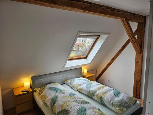 a bedroom with a bed with two pillows on it at Apartment Home 3 in Schwabach