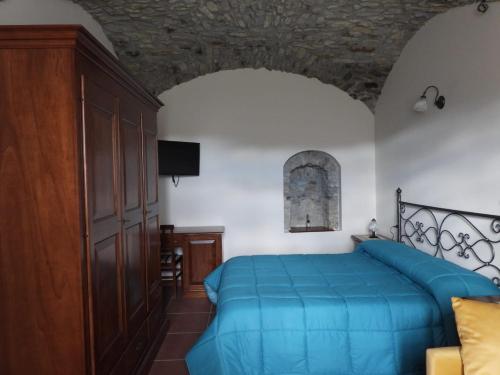 a bedroom with a blue bed and a wooden cabinet at Tenuta Barone in Duronia