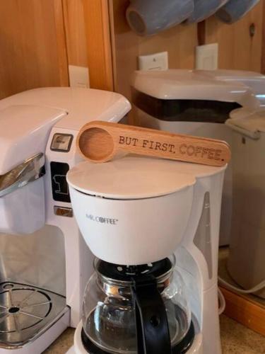 a coffee maker with a wooden spoon on top of it at Knotty but Nice-sleeps 6-one minute to lake! in Three Oaks