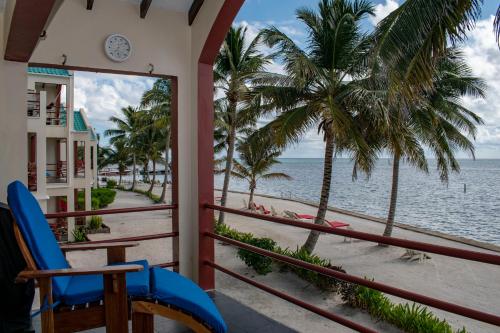 a balcony with a view of the beach at Tres Cocos Resort in San Pedro
