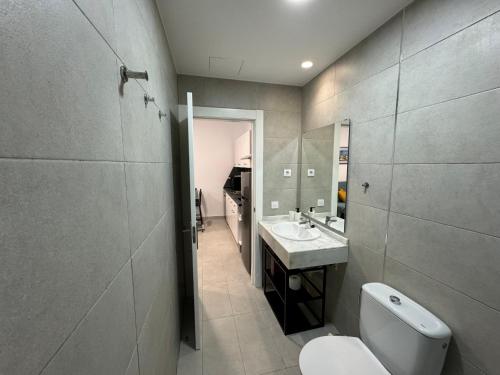 a bathroom with a toilet and a sink at Casa Sofia - Costa Calma Sun & Beach in Costa Calma