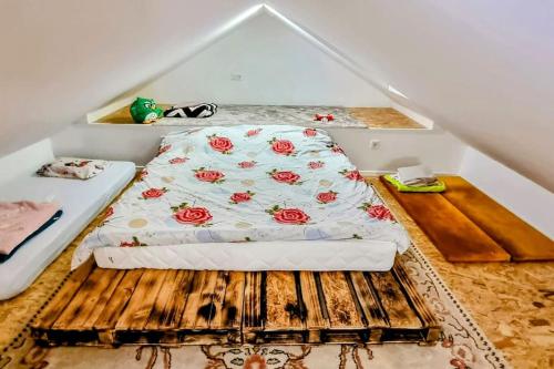 a bedroom with a bed with flowers on it at 7Pines Bijambare - Air Spa in Sarajevo